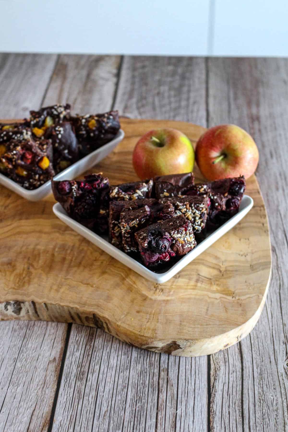 Chocolate Protein Baked Oats with apples on the background.