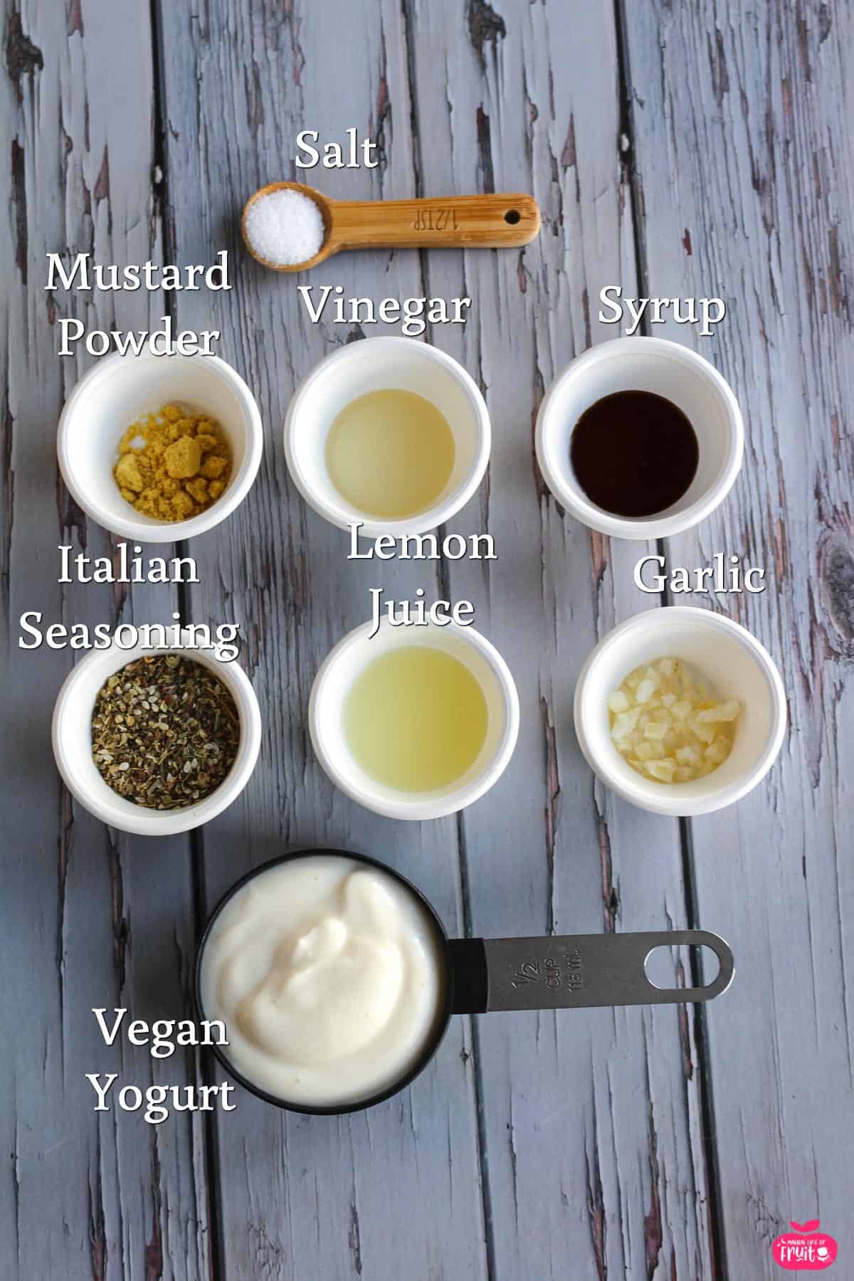 Ingredients for Creamy Vegan Italian Dressing Recipe, salt, mustard powder, vinegar, syrup, Italian seasoning, lemon juice, garlic, vegan yogurt.