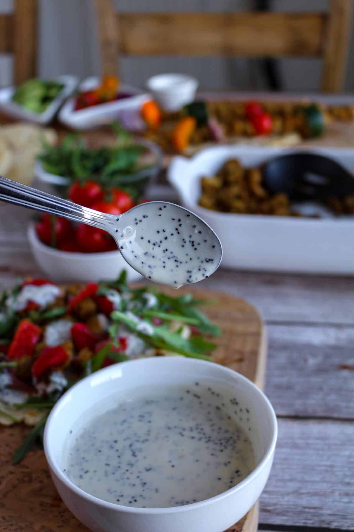 Creamy Vegan Poppy Seed Dressing scooped to a spoon.