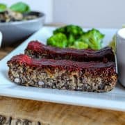 Easy Vegan Meatloaf With Mushrooms And Oats on a white plate.