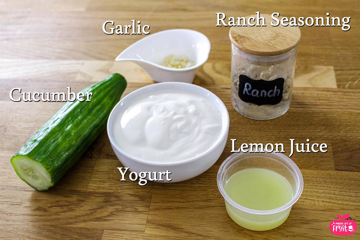 Easy Vegan Tzatziki Sauce ingredients, cucumber, garlic, ranch seasoning, yogurt & lemon juice.