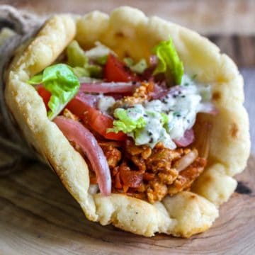 Vegan Gyros flatbread wrap with with jackfruit, onion, sauce and salad