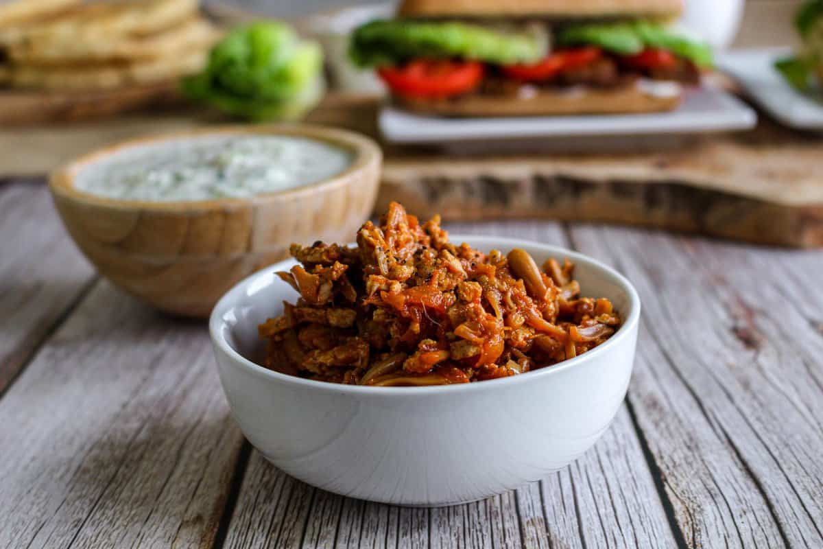 Vegan Jackfruit shredded chicken on a table with a dip
